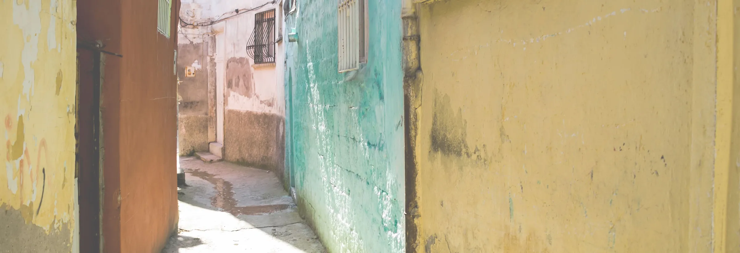 A narrow stone street in old Antakya, lined with weathered doorways
