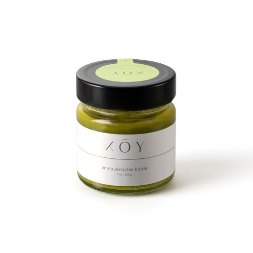 A jar of Koy Antep pistachio butter, green under a black lid with a green seal