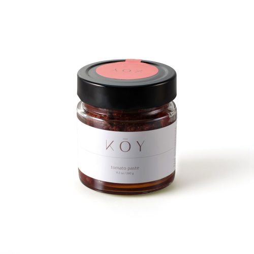 A jar of Koy tomato paste, deep red under a black lid with a red seal